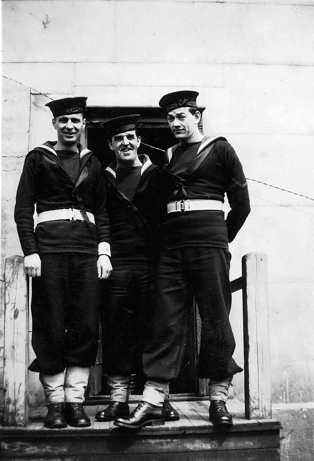 Three unidentified shore patrol.