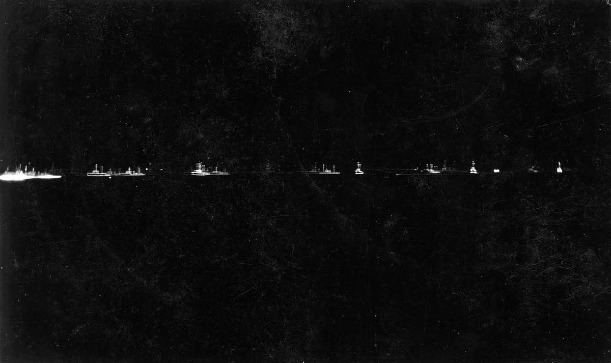 Line of illuminated navy ships.