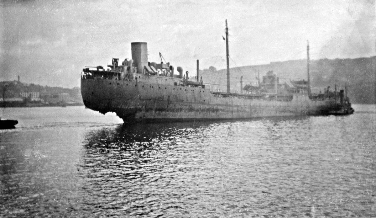 Tanker with rudder blown off by torpedo