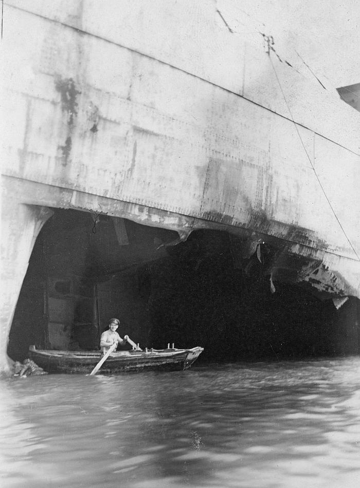 Examining large hole left by torpedo