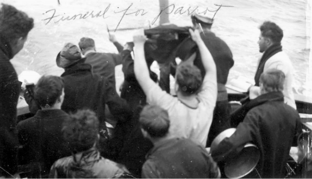 Funeral at sea for ship's parrot.