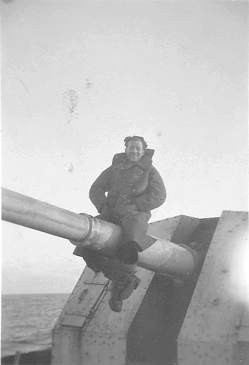 Unidentified man straddling gun barrel.