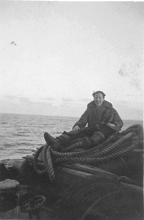 Unidentified man on coil of rope.